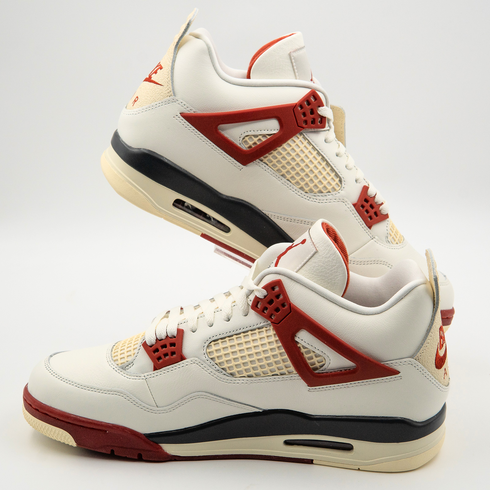 Nigel Sylvester Air Jordan 4 Brick After Brick pair in a diagonal side view on a clear mount